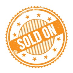 SOLD ON text written on orange grungy round stamp.