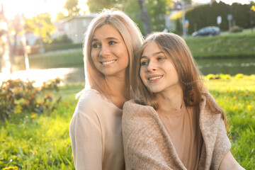 Fototapeta premium Happy mother with her daughter spending time together in park on sunny day