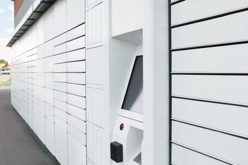 Modern parcel locker with many postal boxes outdoors