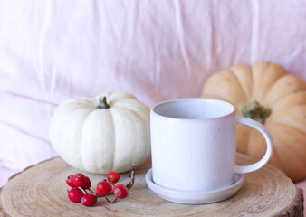 Cozy autumn morning breakfast in bed still life scene. A steaming cup of hot coffee, pumpkins.Fall, Thanksgiving concept.Side view.