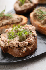 Slices of bread with delicious pate on light grey table, closeup