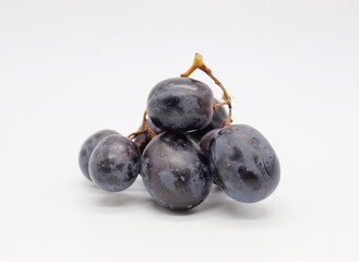 group of purple grapes on white background
