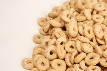 Corn rings on a white background. view from above. Quick breakfast cereal.