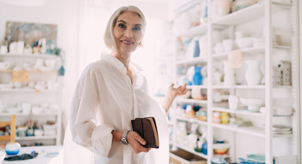 Female entrepreneur with notebook at art studio