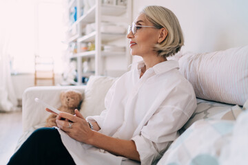 Fototapeta premium Caucasian woman with smartphone at art studio