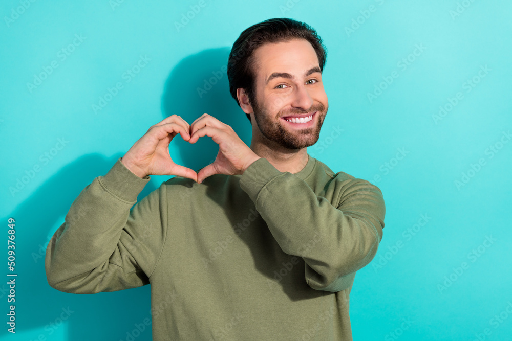 Poster photo of cool brunet young guy hands heart wear khaki sweatshirt isolated on teal color background