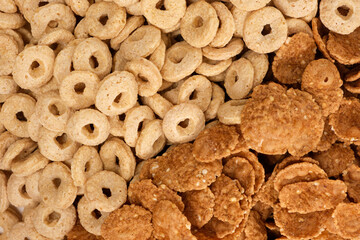 Close-up of wheat flakes and corn rings, top view.