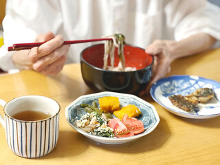 和食を食べる高齢女性の手元