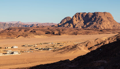 Fototapeta na wymiar Small village in the valley in Sinai mountains. Saint Catherine, Sinai peninsula, Egypt