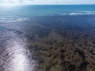 Amazing coral reef in the middle of the sea in Porto Seguro, Bahia, Brazil - natural beauty aerial drone view