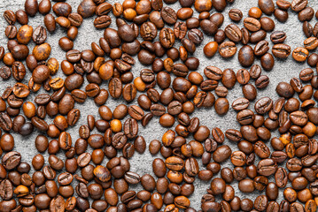 Roasted Coffee Beans on the Stone Background.