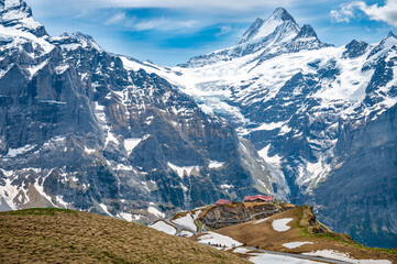 Cliff walk  at First peak above Grindelwald village and surrounded snowy Alps.  Jungfrau region, Switzerland.