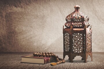A Arabian Muslim lantern is placed on a wooden table. Muslim feast of the holy month of Ramadan...