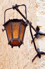 An antique lantern on the wall of a traditional stone house in Mdina, also called the Silent City. Malta, Europe. 