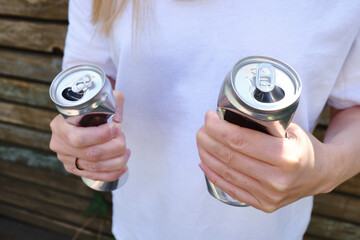 Crumpled tin can in hand. Recyclable material. Environmental protection. Zero waste. Used beverage...