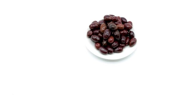 an olive branch with ripe black olives on isolated white background