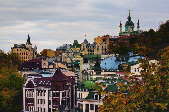 Picturesque autumn landscape of colored roofs of Andrew's Descent (Andriyivsky uzviz, Podil neighborhood). Famous Saint Andrew's Church and house number 15th, called The Richard's Castle-Lion Heart