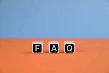 FAQ or frequently asked questions inscription on white cubes.