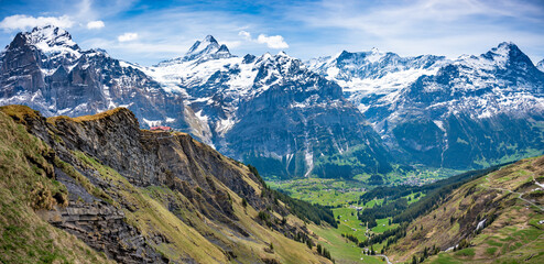 Fototapeta na wymiar Cliff walk at First peak above Grindelwald village and surrounded snowy Alps. Jungfrau region, Switzerland.