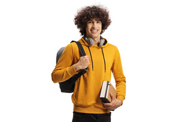 Smiling male student carrying a backpack and a book