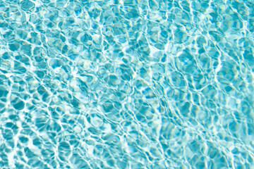 rippled water turquoise color in summertime swimming pool