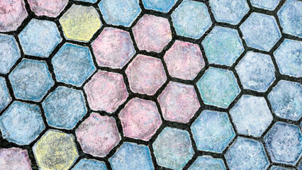 Colorful floor motif of hexagon cement bricks for your design concept.  Geometric background pattern of rough cement floor. Paving block motif. Colorful hexagon background pattern.