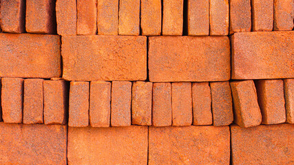 Fototapeta premium Red brick wall. Closeup view of red bricks as building materials