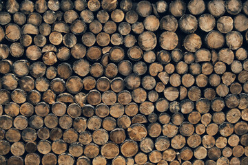 Pile stacked natural sawn wooden logs, background