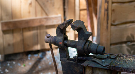 Blacksmith with red-hot iron at work