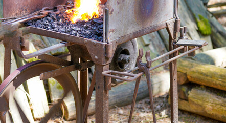 Blacksmith with red-hot iron at work