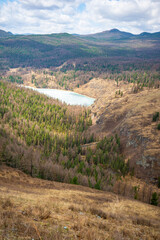 Fototapeta na wymiar Aerial view of large frozen lake in the spring mountains of Altai, Russia