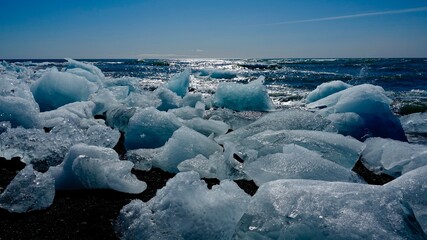 Eisberge und Eisstücke im Sonnenschein am Gletscher in Island.