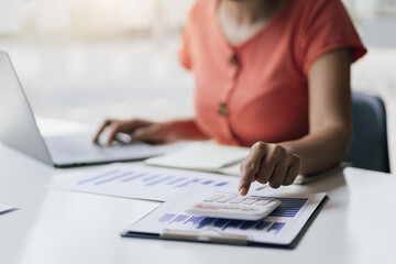 Accountant working on desk office with using a calculator to calculate the numbers and audit. Finance accounting concept.