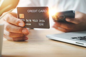 Online payment, Man's Hands holding credit card and using laptop, online credit card payment for purchases from online, Online shopping.