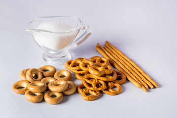 Mini Pretzels Mini Bagel Bread Sticks with Salt on Blue Background Snacks for Beer Horizontal