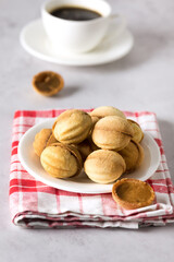 Still life Composition with White Plate Cup of Coffee Walnuts Sweet Cookies Shaped Nuts on Grey Background Food Concept Vertical
