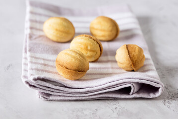 Delicious Walnut Shaped Shortbread Sandwich Cookies Filled with Sweet Condensed Linen Napkin Milk Gray Background Horizontal