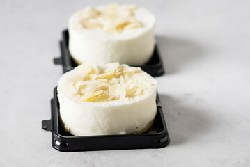 Tasty Round White Mini Cheesecake Decoreated with Almond Modern Dessert Minimalism Gray background