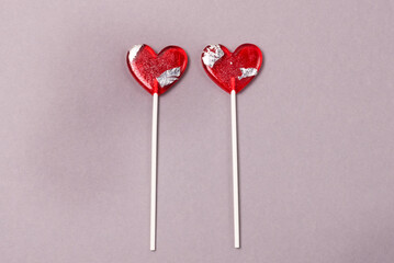 Two Heart Shape Lollipop Candy on Gray Paper Background Love Concept Top View Minimalism Style Horizontal