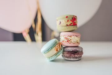 Fototapeta premium Macaroons close-up on a white table in a cafe