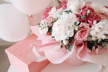 Bouquet of peonies and gift pink box, birthday concept