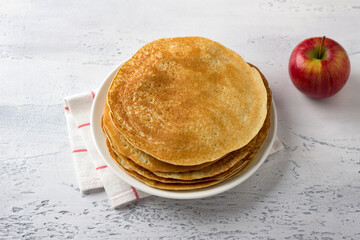 Apple pancakes on a light gray background, top view. Delicious homemade food