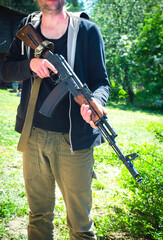 Fototapeta premium An armed man with a machine gun. Ukraine