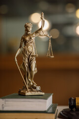 Statue of Lady Justice with scales of justice and wooden judge gavel on wooden table. Panoramic...