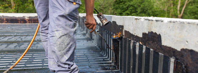 Bituminous membrane waterproofing system details and installation on flat rooftop.