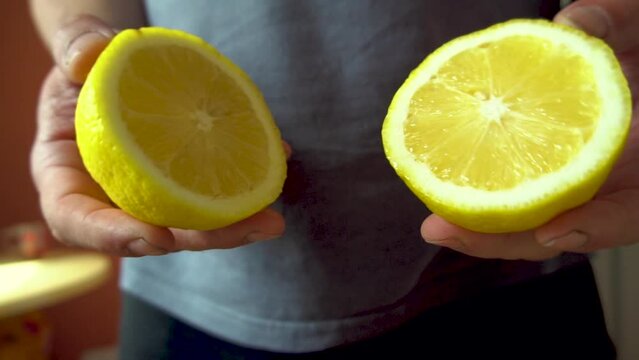 Male hands hold lemon slices. tropical fruit. Preparing a drink. Close-up. dietary product. Vitamin C. Sour taste. Slow motion.