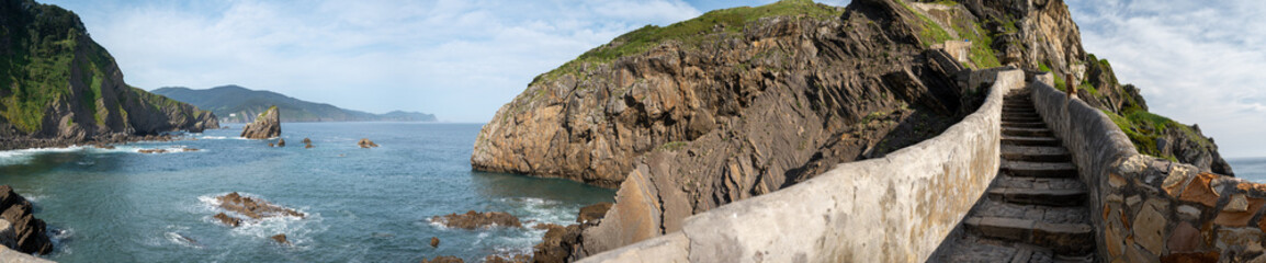 Stone footpath to famous landmark and film location in North of Spain, ocean islet with chapel San juan de gaztelugatxe, Basque Country, Spain