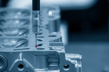The  CMM machine measuring the cylinder head parts .