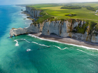 Aerian view on chalk cliffs near Porte d'Aval arch in Etretat on green meadows and blue water of...