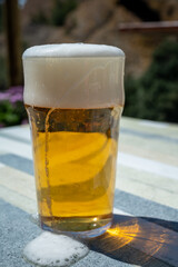 Glass of fresh cold lager beer served outdoor in snack bar with view on Calanque de Figuerolles in La Ciotat, Provence, France